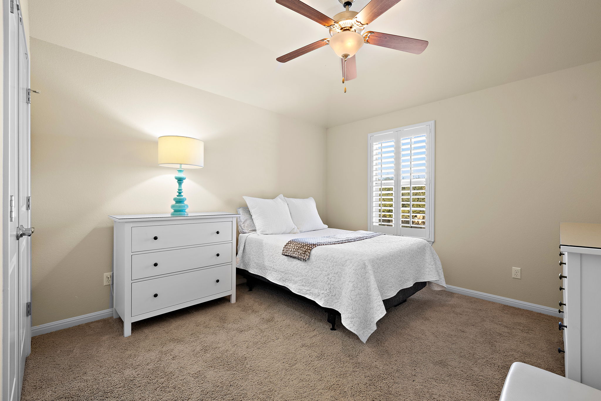 4413 Tambre Bend Austin, TX 78738 - Photo 25 of 30 a spacious bedroom with a bed and a chandelier