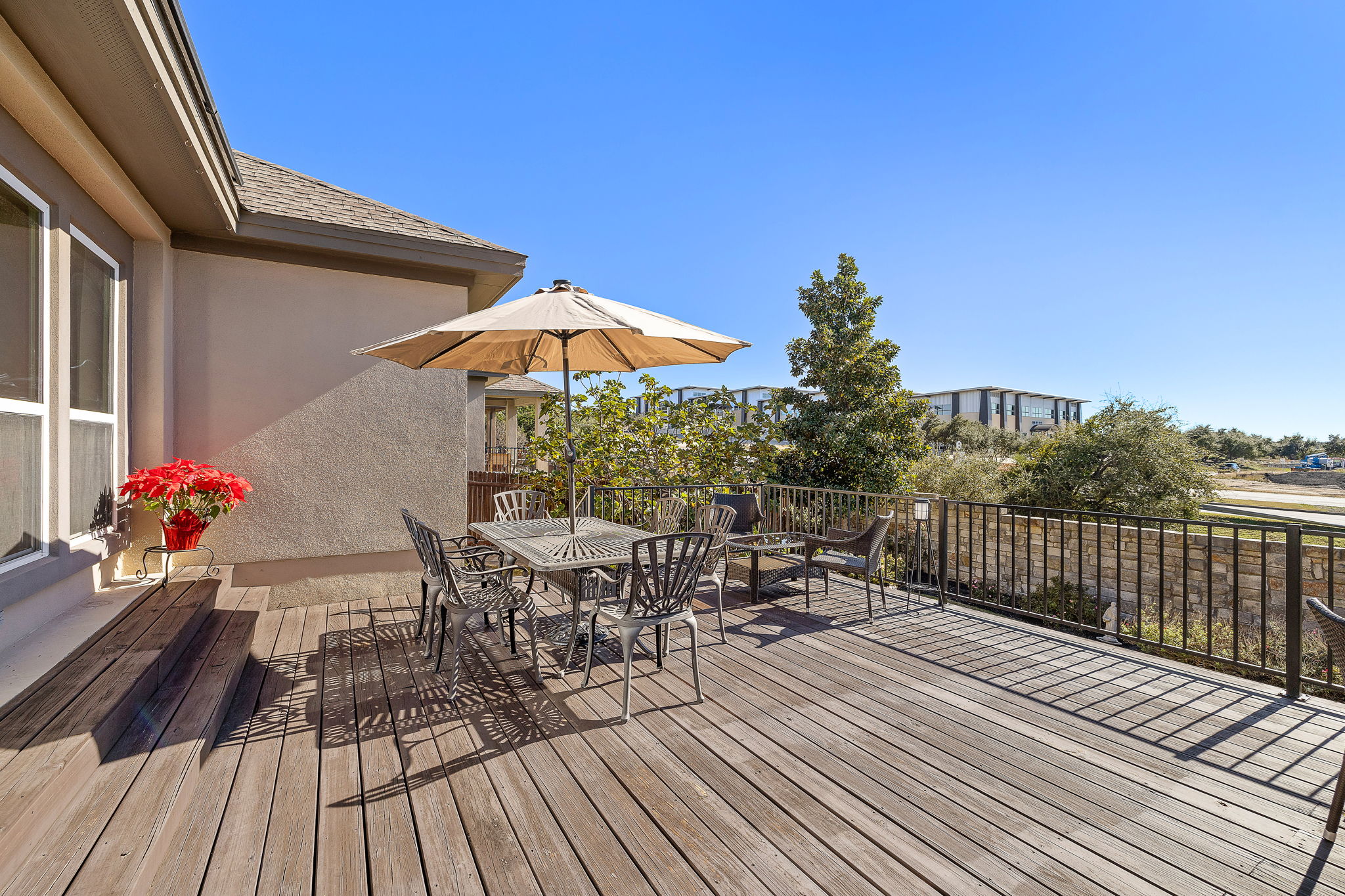 4413 Tambre Bend Austin, TX 78738 - Photo 28 of 30 a view of a roof deck with table and chairs and wooden floor