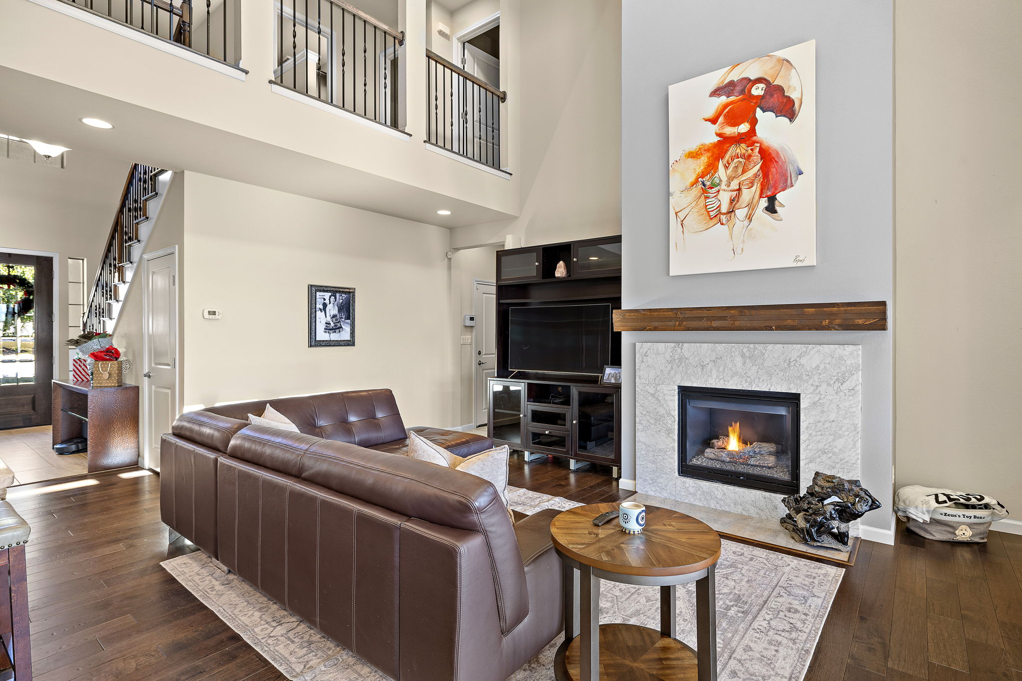 4413 Tambre Bend Austin, TX 78738 - Photo 3 of 30 a living room with furniture a flat screen tv and a fireplace