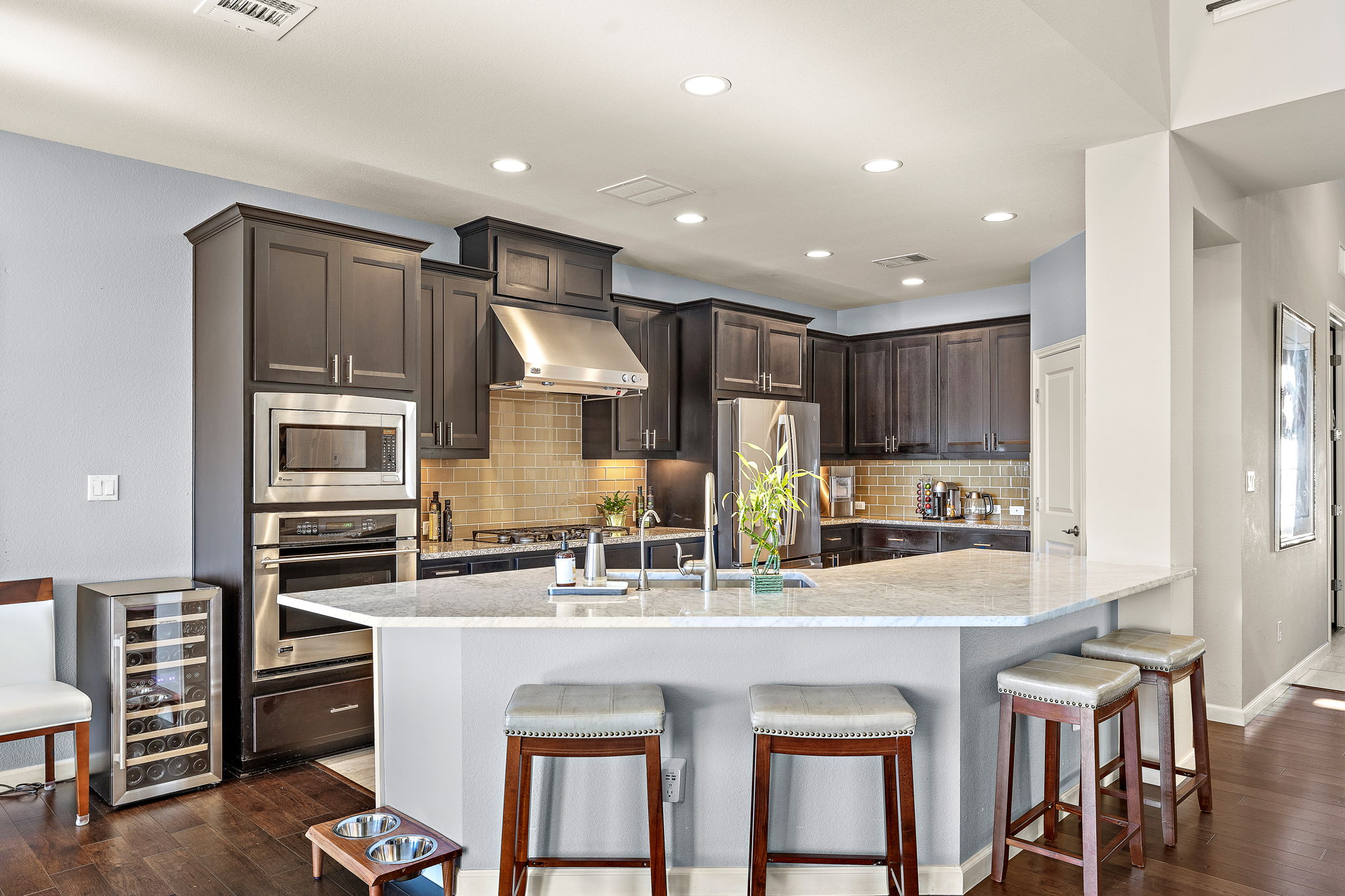 4413 Tambre Bend Austin, TX 78738 - Photo 6 of 30 a kitchen with stainless steel appliances kitchen island granite countertop a refrigerator and cabinets