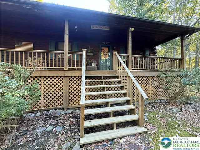 a view of a house with wooden deck