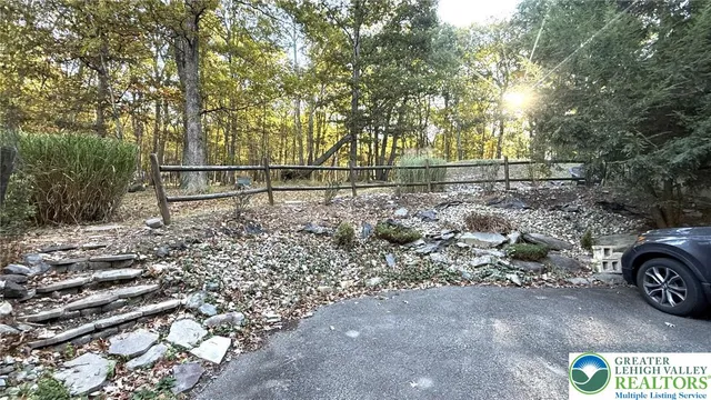 a view of a yard with wooden fence
