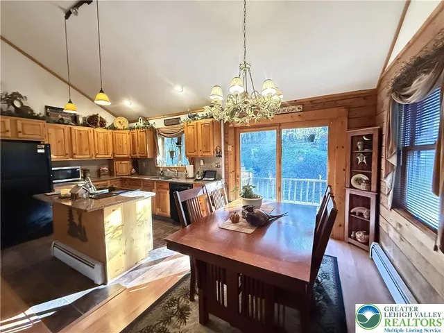 a view of a dining room with furniture a chandelier and wooden floor