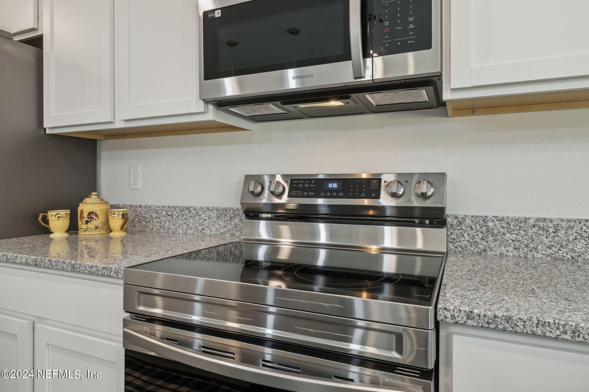 8320 Maple Street Jacksonville, FL 32244 - Photo 14 of 32 a kitchen with granite countertop stainless steel appliances and cabinets