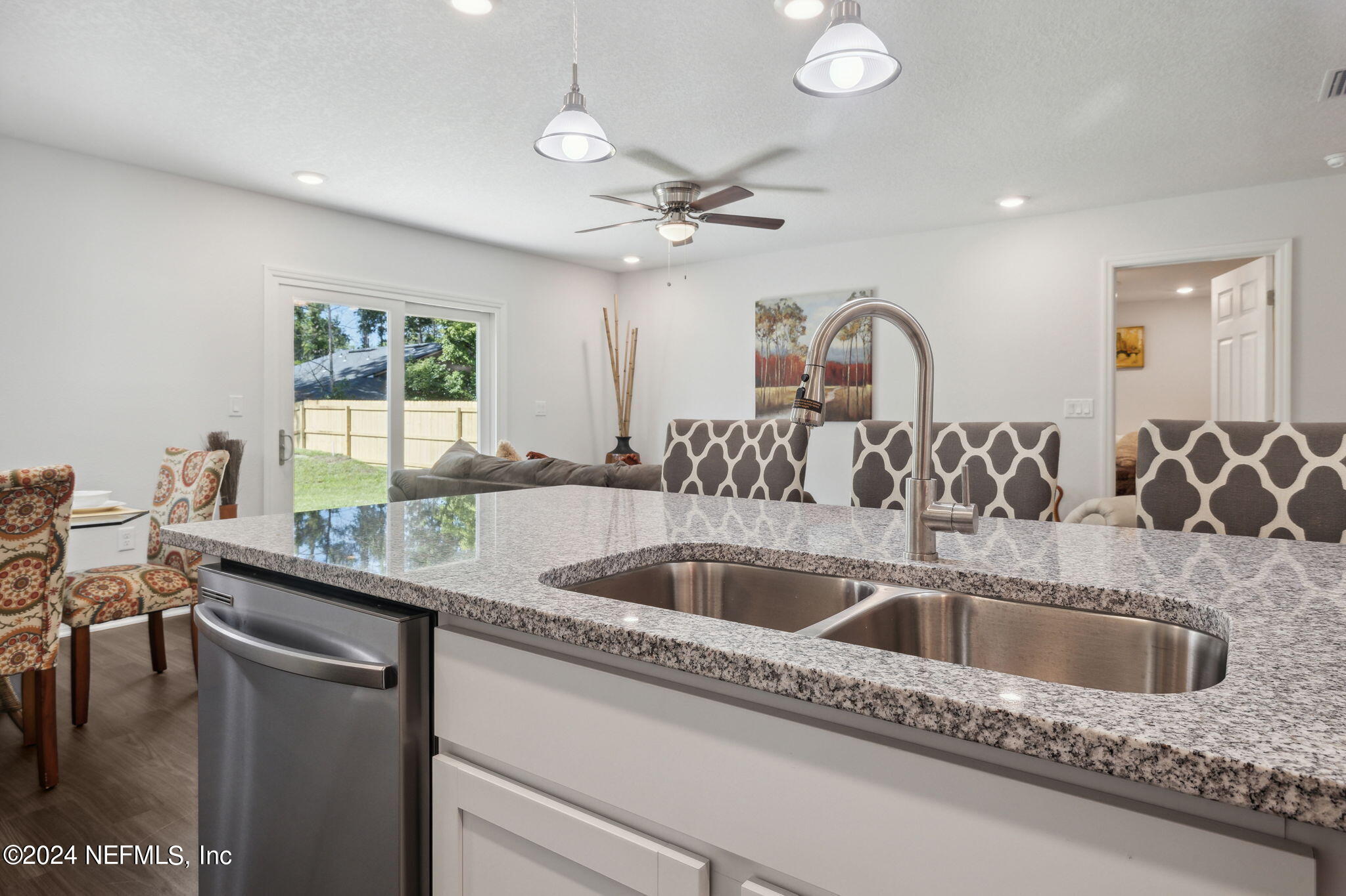 8320 Maple Street Jacksonville, FL 32244 - Photo 15 of 32 a kitchen with a sink a counter top space and living room view