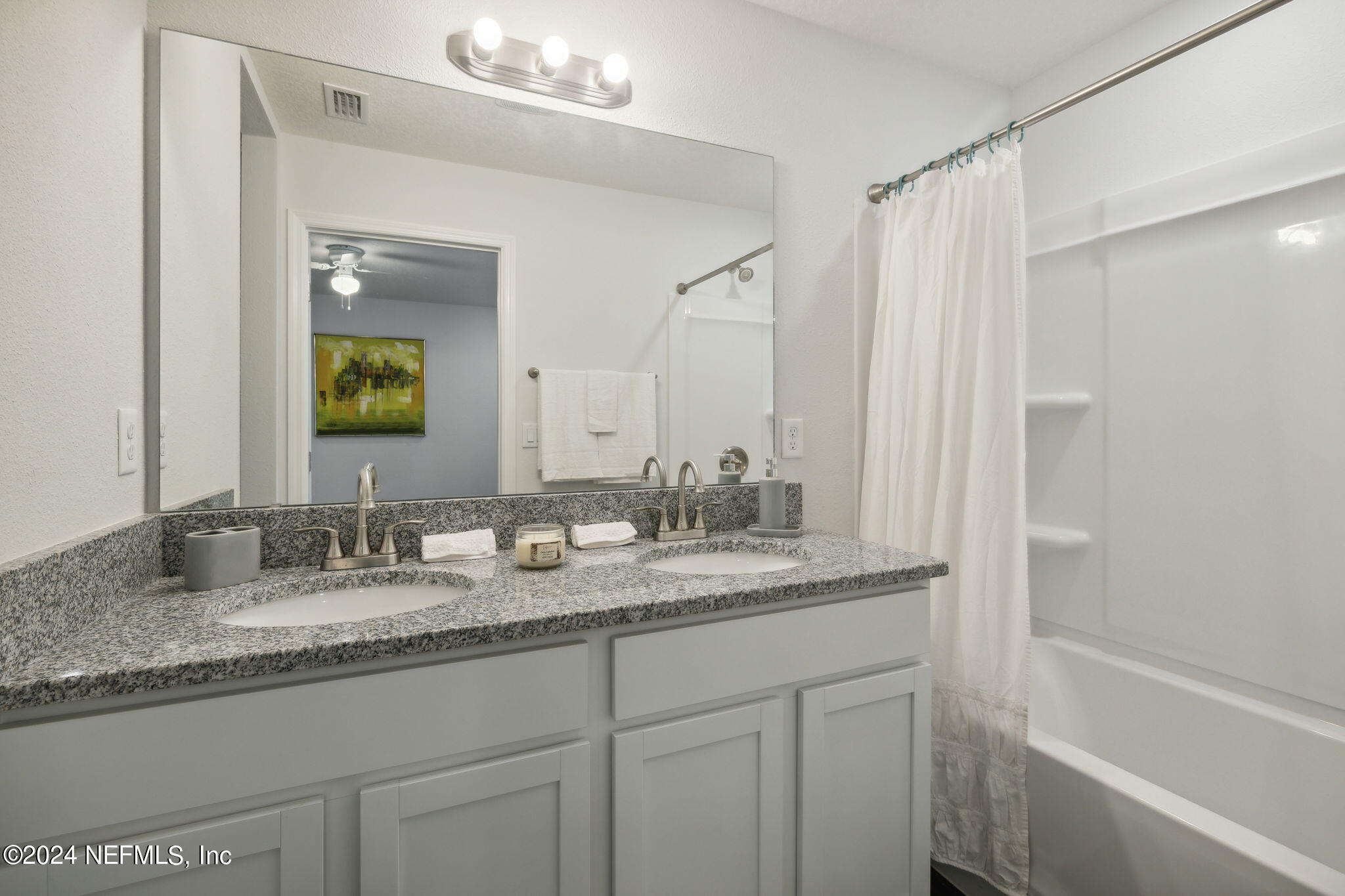 8320 Maple Street Jacksonville, FL 32244 - Photo 18 of 32 a bathroom with a granite countertop sink and a mirror