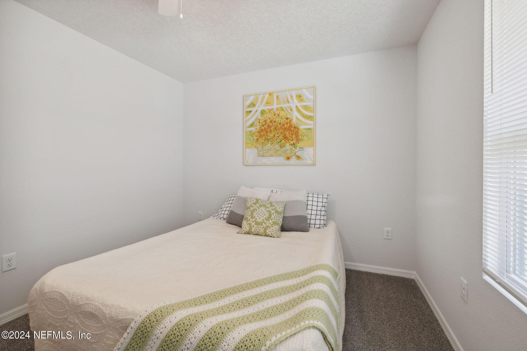 8320 Maple Street Jacksonville, FL 32244 - Photo 21 of 32 a bedroom with a bed and painting on the wall