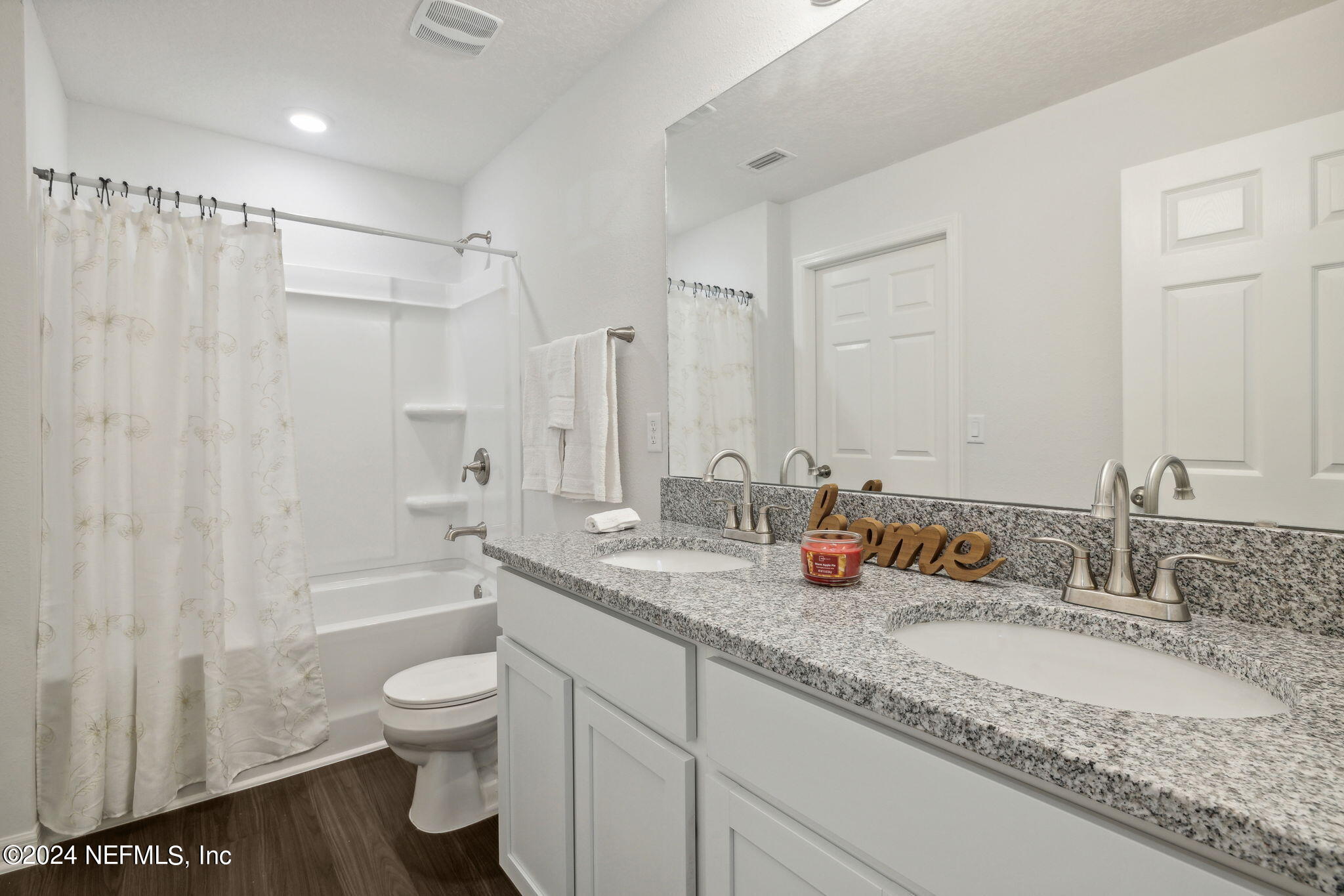 8320 Maple Street Jacksonville, FL 32244 - Photo 24 of 32 a bathroom with a granite countertop sink mirror vanity and toilet
