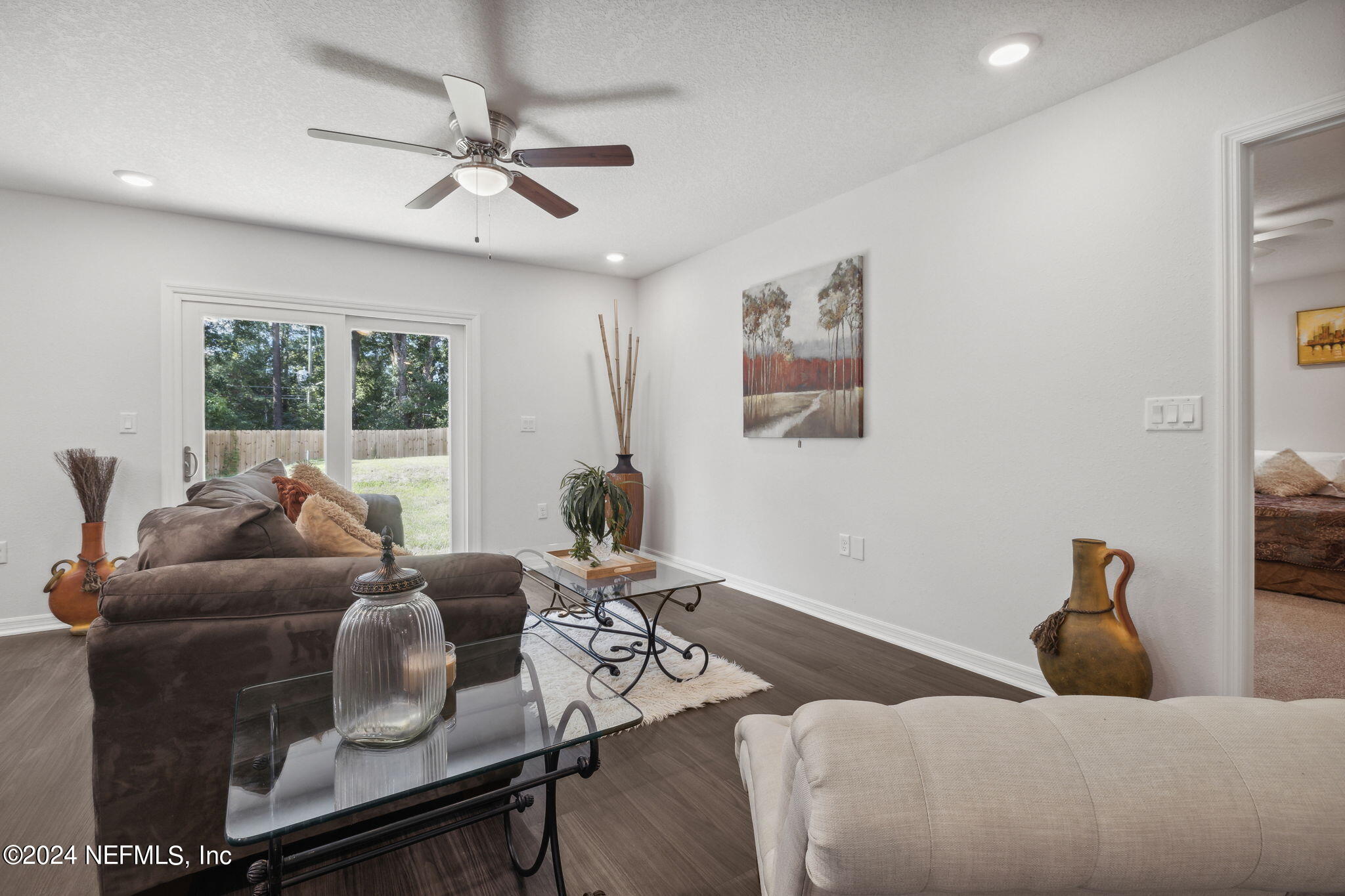 8320 Maple Street Jacksonville, FL 32244 - Photo 8 of 32 a living room with furniture and a large window