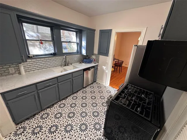 a kitchen with a sink stove and refrigerator
