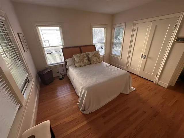 a bedroom with a bed and a large window