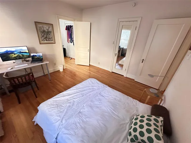 a bedroom with a bed and a desk