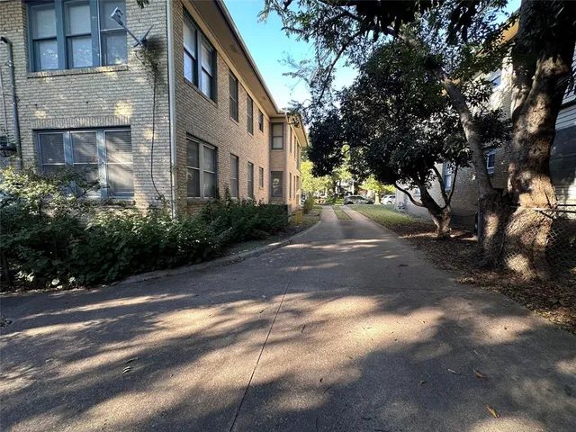 a view of a street with a building in the background