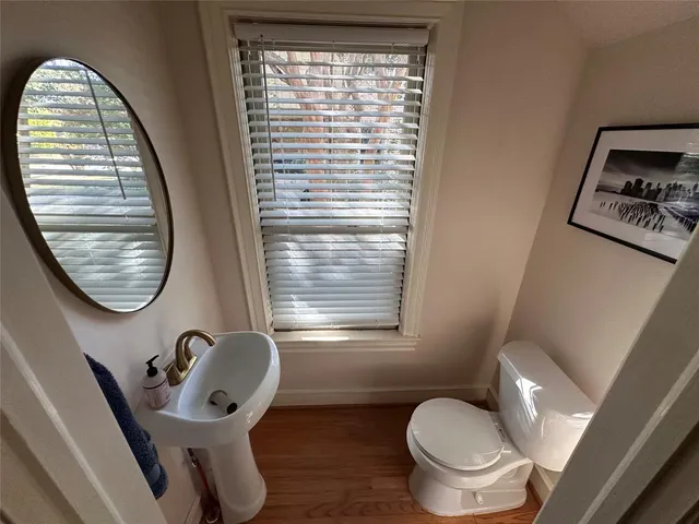a bathroom with a toilet a sink and a mirror