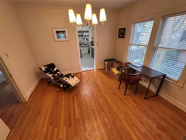 a view of a workspace with furniture and wooden floor