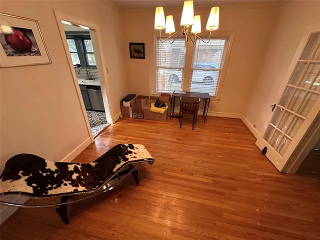 a living room with furniture floor to ceiling window and wooden floor