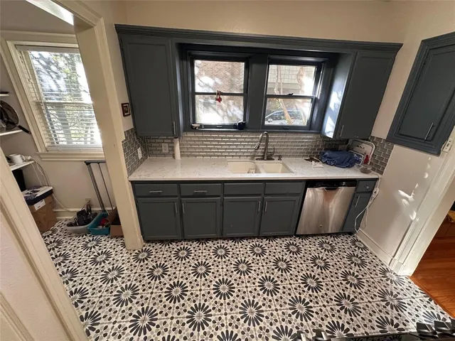 a room with a black white checkered floor and a large mirror
