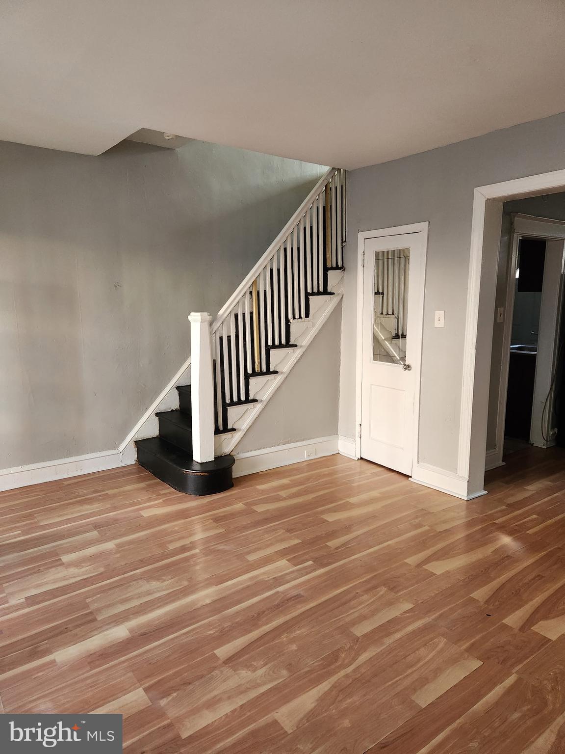 2034 East Rittenhouse Street Philadelphia, PA 19138 - Photo 1 of 8 a view of an empty room with wooden floor and stairs