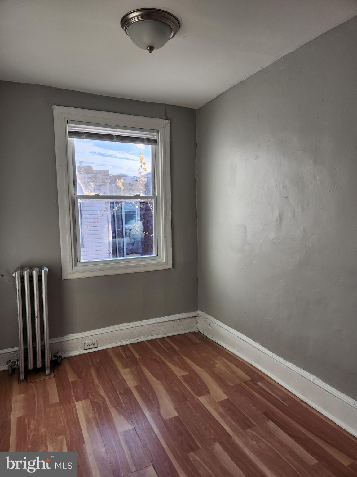 2034 East Rittenhouse Street Philadelphia, PA 19138 - Photo 5 of 8 an empty room with wooden floor and windows