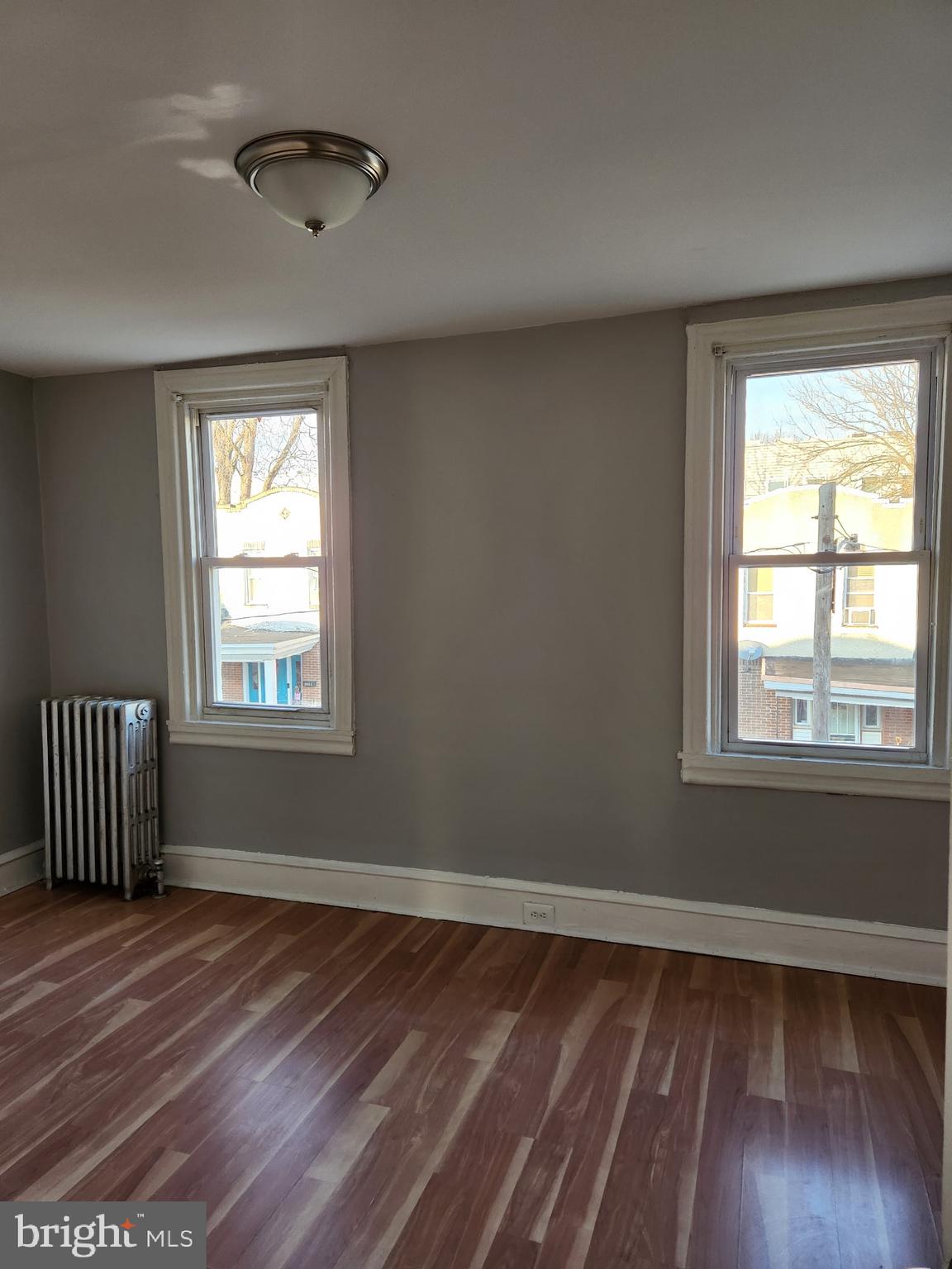 2034 East Rittenhouse Street Philadelphia, PA 19138 - Photo 7 of 8 a view of an empty room with wooden floor and a window