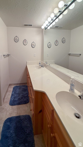 143 East Chestnut Street Helper, UT 84526 - Photo 29 of 35 Full bath featuring double vanity and a textured ceiling