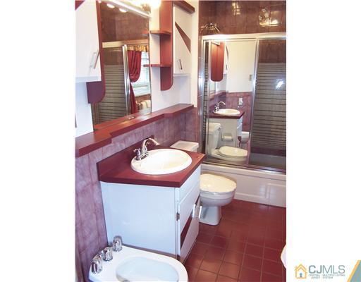 2 Crabtree Road Old Bridge, NJ 07747 - Photo 11 of 13 a bathroom with a toilet a sink and mirror