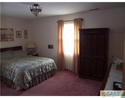 2 Crabtree Road Old Bridge, NJ 07747 - Photo 12 of 13 a bedroom with a bed and a window