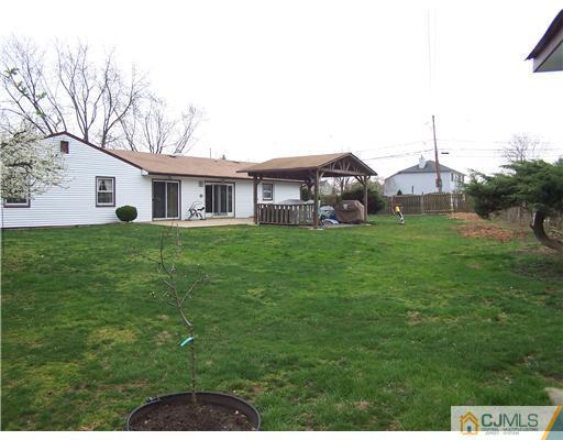 2 Crabtree Road Old Bridge, NJ 07747 - Photo 13 of 13 a view of a house with a big yard and large trees
