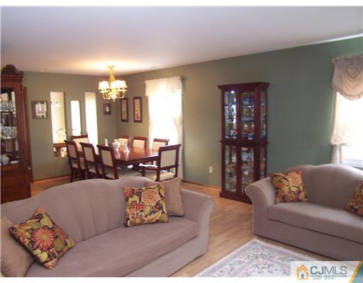 2 Crabtree Road Old Bridge, NJ 07747 - Photo 4 of 13 a living room with furniture and a chandelier