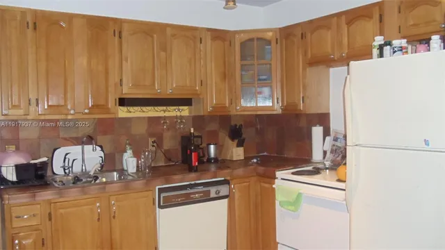 a kitchen with a refrigerator a stove and a cabinets