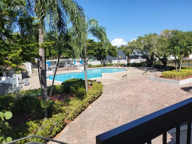 a view of a backyard with swimming pool