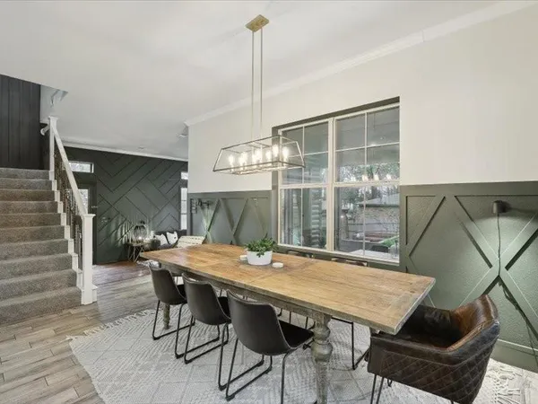 a dining room with furniture and window