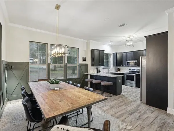 a kitchen with kitchen island a sink table and chairs