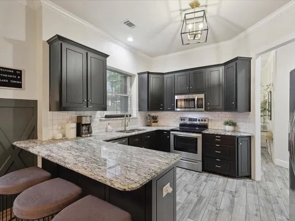 a kitchen with a stove a sink and a refrigerator