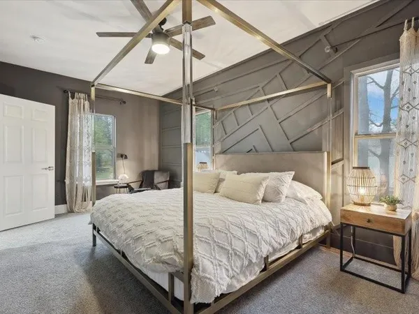 a bedroom with a bed and a window