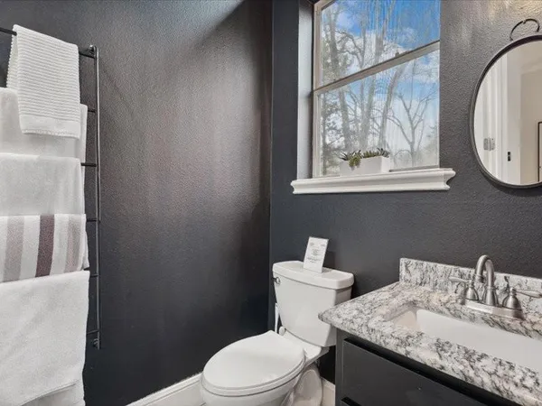 a white toilet sitting next to a bathroom sink