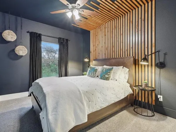 a bedroom with a bed and a window