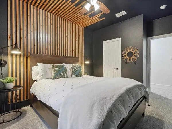 a bedroom with a bed and a chandelier