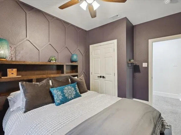 a bedroom with a bed and a painting