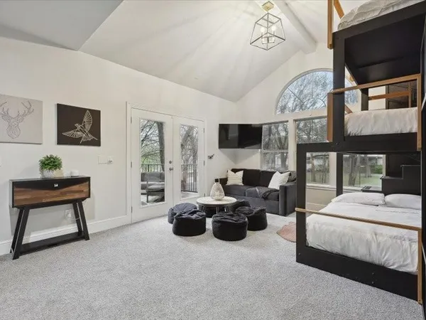 a living room with furniture gym equipment and a large window