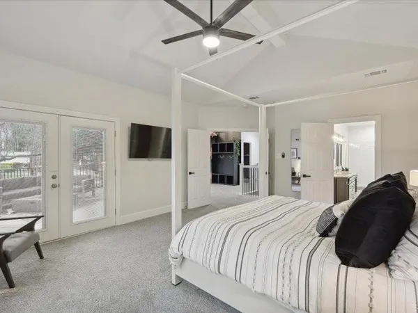 a bathroom with a granite countertop sink a mirror and shower