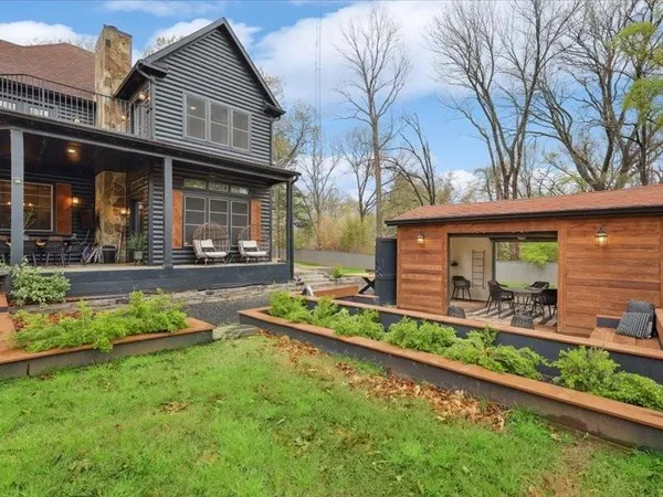 a view of a patio with couches and a potted plant on a table