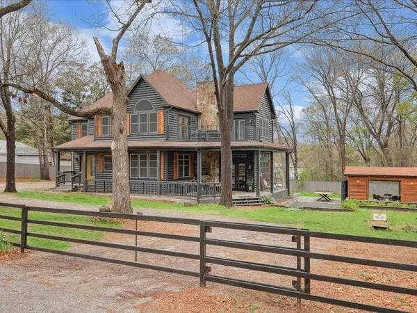 a front view of a house with a yard table and chairs
