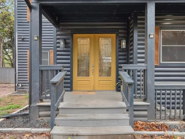 a view of front door of house with stairs