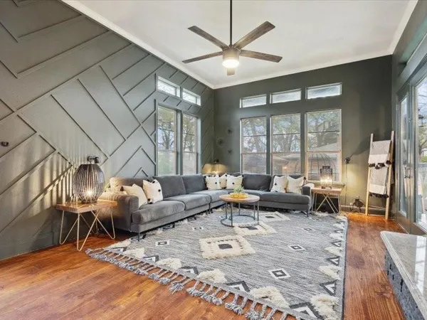 a living room with furniture large window and a table