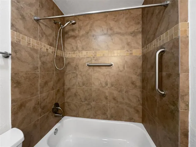 an empty room with a chandelier fan