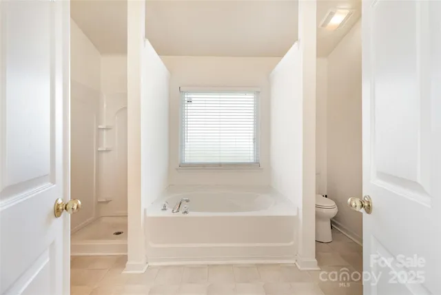 a bathroom with a bathtub and toilet