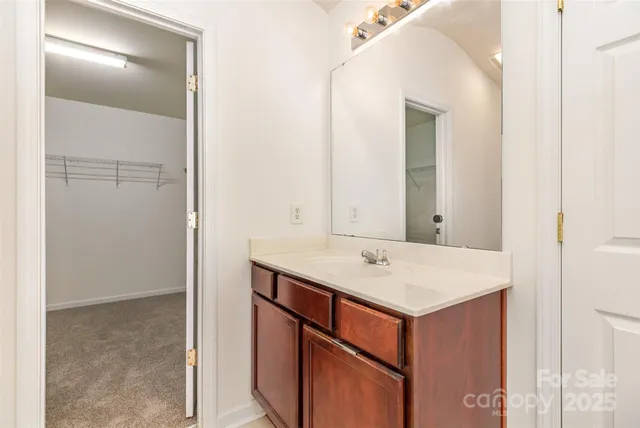 a utility room with a sink and a mirror