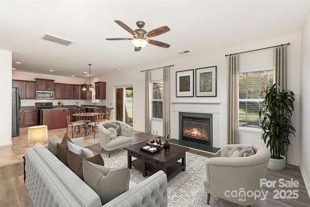 a living room with furniture and a fireplace