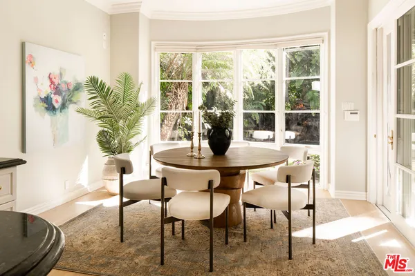 a dining room with furniture and wooden floor